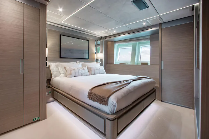 Emina Yacht Photos Pics Luxurious bedroom interior on 2014 Benetti Veloce 140 yacht, featuring modern design and elegant furnishings.