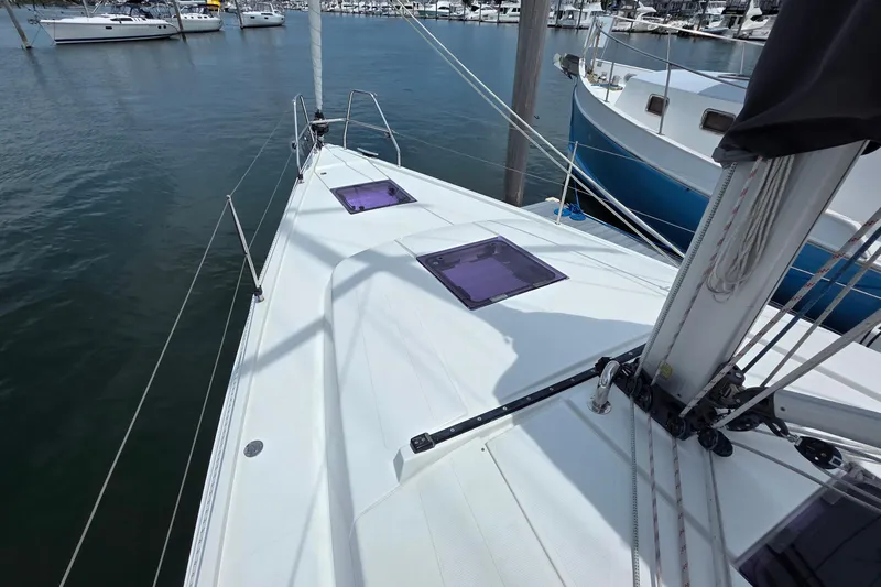 Quantum Yacht Photos Pics Sailboat deck view of 2014 Hanse 385 in marina, showcasing sleek design and rigging.