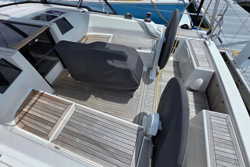 Quantum Yacht Photos Pics 2014 Hanse 385 yacht cockpit with covered steering wheels and wooden deck.