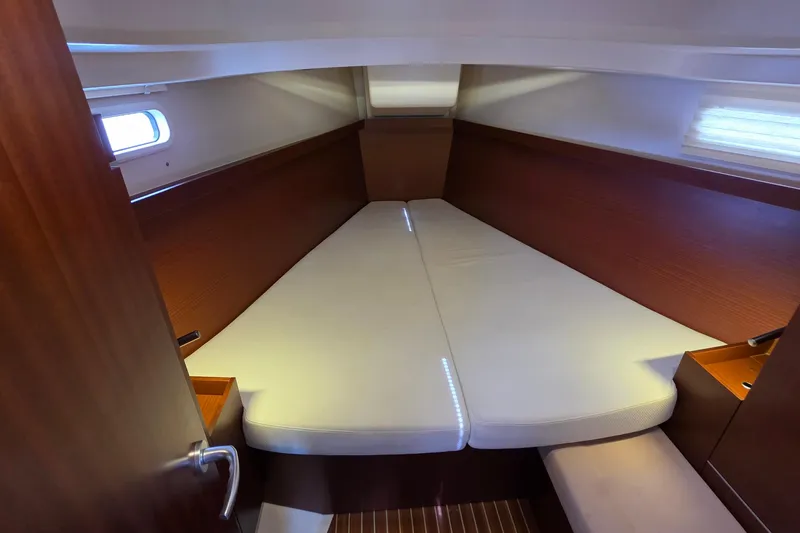 Quantum Yacht Photos Pics Cozy cabin interior of 2014 Hanse 385 yacht with comfortable bedding.