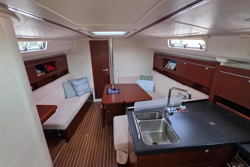 Quantum Yacht Photos Pics Interior of 2014 Hanse 385 yacht with modern kitchen and cozy seating area.