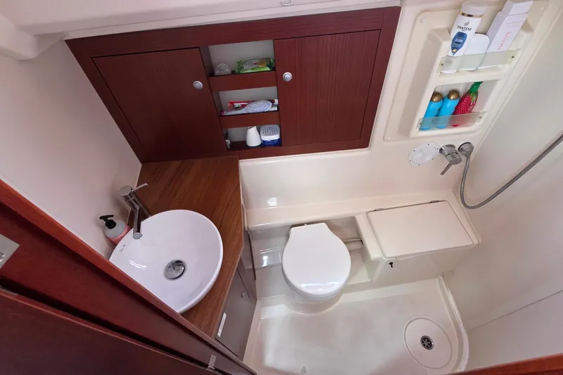 Quantum Yacht Photos Pics Compact bathroom in 2014 Hanse 385 yacht with sink, toilet, and shower amenities.