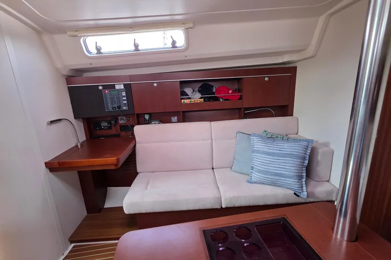 Quantum Yacht Photos Pics Interior of 2014 Hanse 385 yacht with cozy seating and wooden cabinetry.