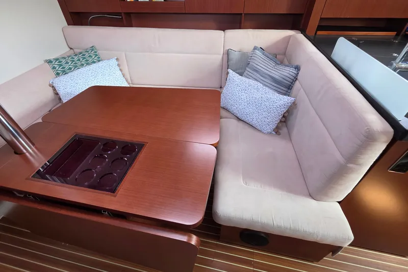 Quantum Yacht Photos Pics Luxurious 2014 Hanse 385 yacht interior with cozy seating and elegant wooden table.