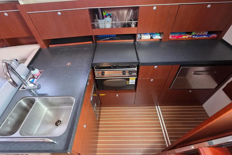 Quantum Yacht Photos Pics Modern kitchen in 2014 Hanse 385 yacht with wood cabinets and dual sink.
