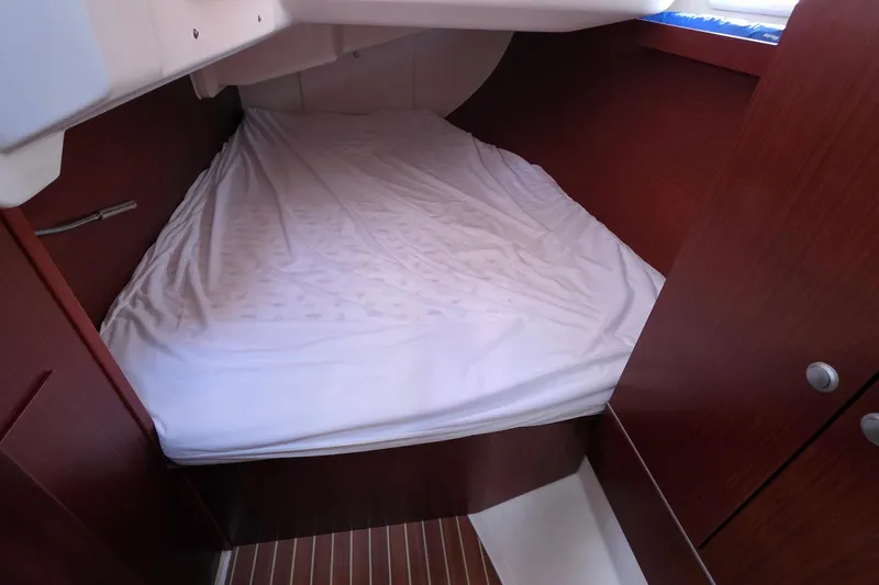 Quantum Yacht Photos Pics Cozy cabin interior of 2014 Hanse 385 yacht with wooden finish and comfortable bedding.