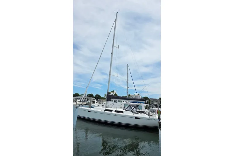 Quantum Yacht Photos Pics 2014 Hanse 385 sailboat docked in a marina under a cloudy sky.