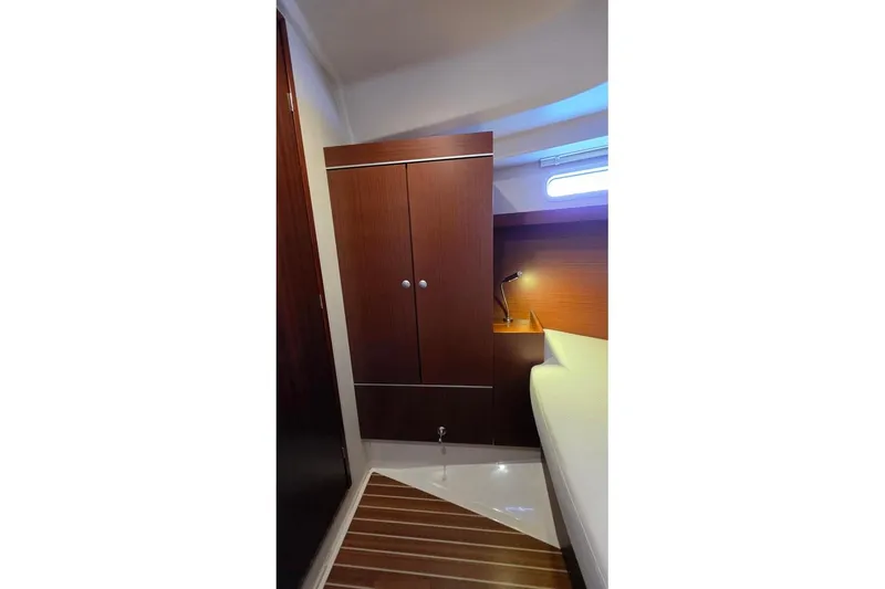 Quantum Yacht Photos Pics Interior of 2014 Hanse 385 yacht cabin with wooden cabinetry and modern lighting.