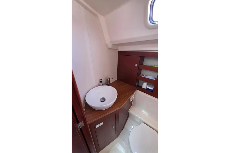 Quantum Yacht Photos Pics 2014 Hanse 385 yacht bathroom with modern sink and wooden cabinetry.