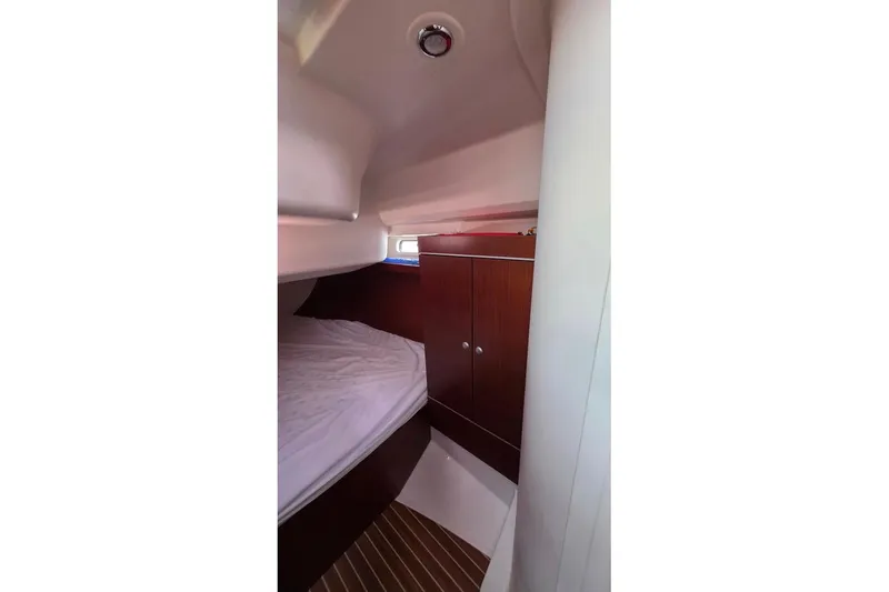 Quantum Yacht Photos Pics 2014 Hanse 385 yacht cabin interior with bed and wooden cabinetry.