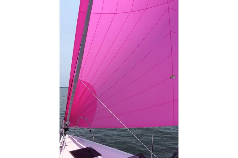 Quantum Yacht Photos Pics Pink sail on a 2014 Hanse 385 yacht against the sea.