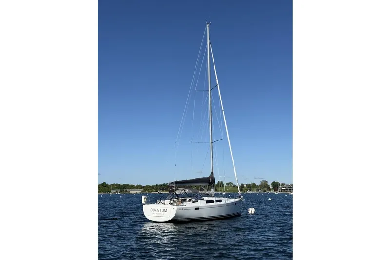 Quantum Yacht Photos Pics 2014 Hanse 385 sailboat on calm water under clear blue sky.