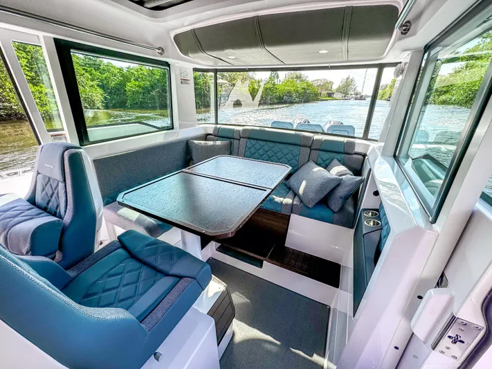  Yacht Photos Pics Luxurious interior of 2024 Axopar 37XC CROSS CABIN with elegant seating and scenic water views.
