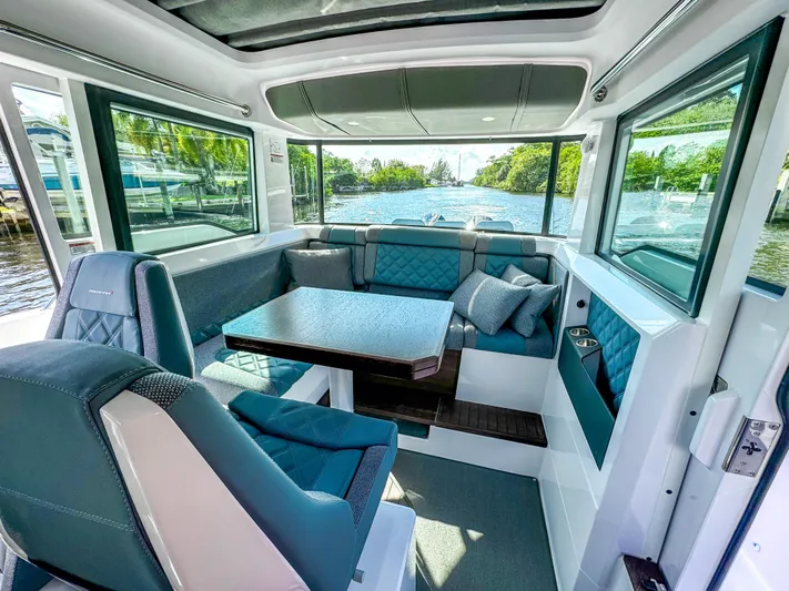  Yacht Photos Pics Luxurious interior of 2024 Axopar 37XC CROSS CABIN with plush seating and scenic water view.