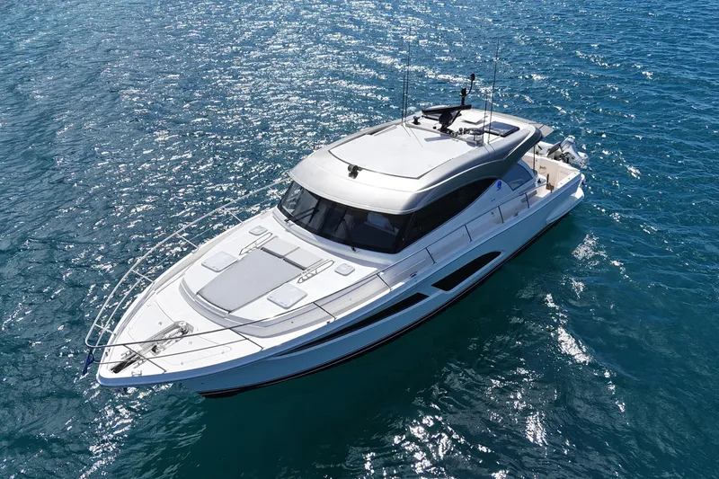  Yacht Photos Pics 2023 Riviera 465 SUV yacht cruising on clear blue ocean waters.