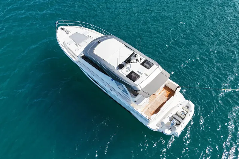  Yacht Photos Pics Aerial view of 2023 Riviera 465 SUV yacht on clear blue water.