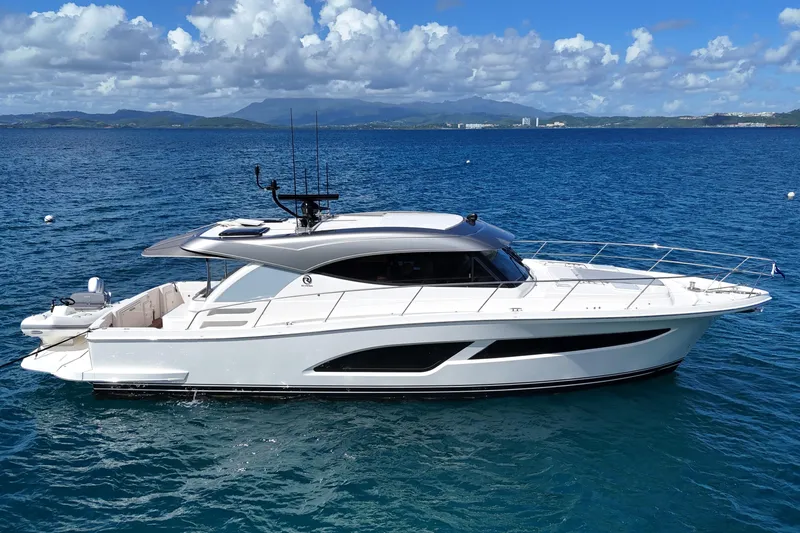  Yacht Photos Pics 2023 Riviera 465 SUV yacht on blue ocean with scenic background.