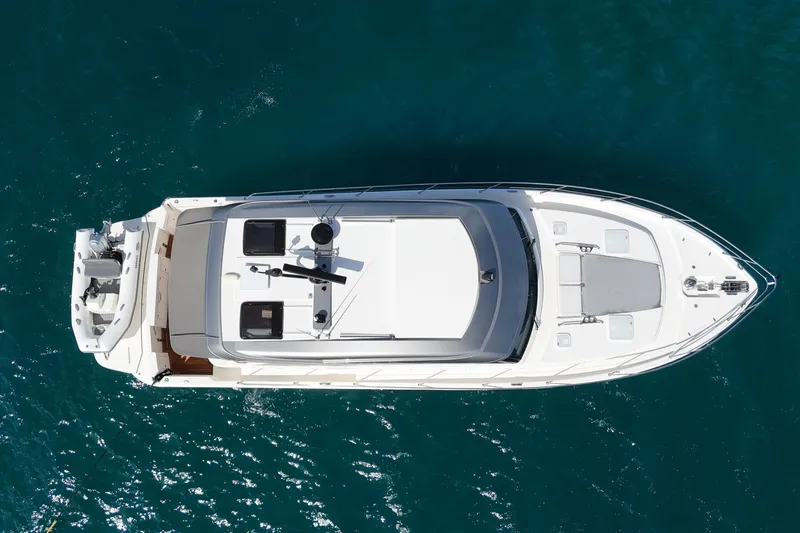  Yacht Photos Pics Aerial view of 2023 Riviera 465 SUV yacht on blue ocean water.