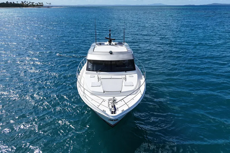  Yacht Photos Pics 2023 Riviera 465 SUV yacht cruising on clear blue ocean waters.