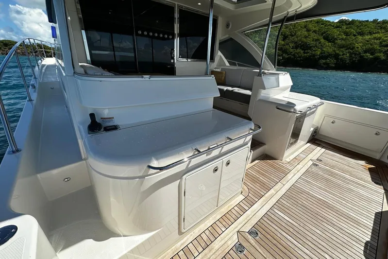  Yacht Photos Pics 2023 Riviera 465 SUV yacht deck with sleek design and luxurious seating.