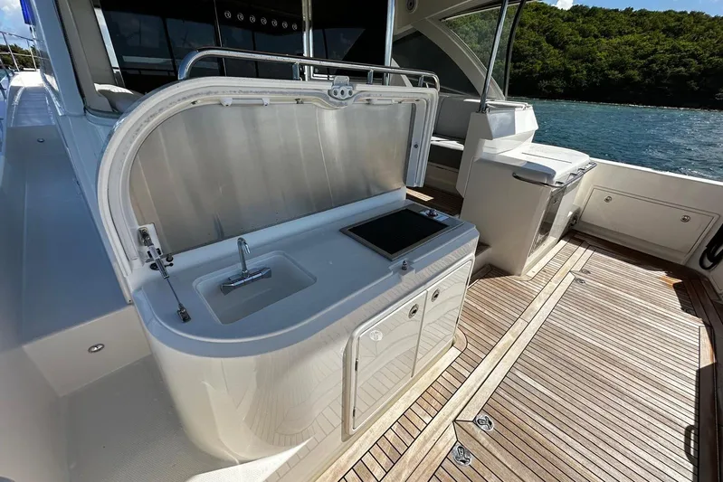  Yacht Photos Pics 2023 Riviera 465 SUV yacht deck with sink and wooden flooring.