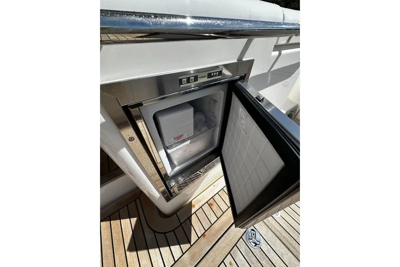  Yacht Photos Pics Open fridge on 2023 Riviera 465 SUV yacht, showcasing sleek design and functionality.