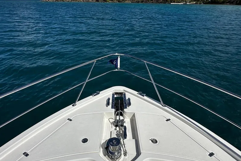  Yacht Photos Pics Bow view of 2023 Riviera 465 SUV yacht on open water.