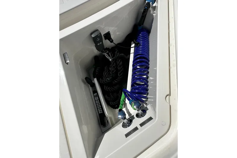  Yacht Photos Pics Storage compartment in 2023 Riviera 465 SUV with coiled hose and accessories.