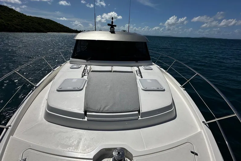  Yacht Photos Pics 2023 Riviera 465 SUV yacht on open water under clear blue sky.