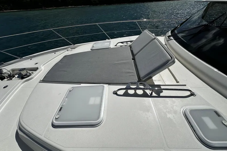  Yacht Photos Pics 2023 Riviera 465 SUV yacht deck with sunbed and ocean view.