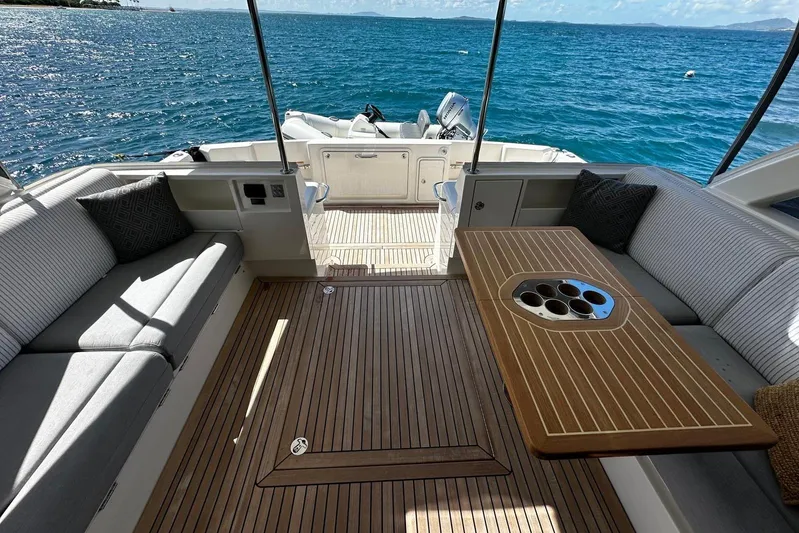  Yacht Photos Pics Luxurious 2023 Riviera 465 SUV yacht interior with elegant seating and ocean view.