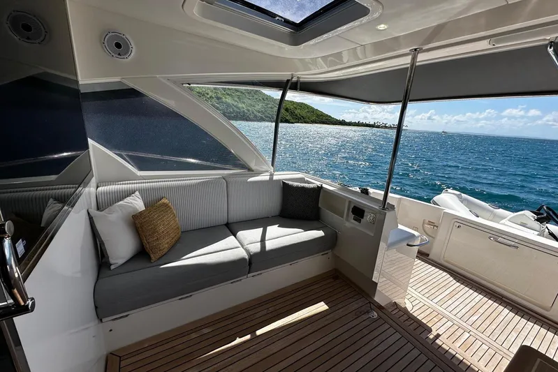  Yacht Photos Pics Luxurious 2023 Riviera 465 SUV yacht interior with ocean view and comfortable seating.
