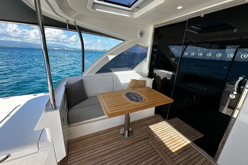  Yacht Photos Pics Luxurious 2023 Riviera 465 SUV yacht interior with ocean view and elegant seating area.