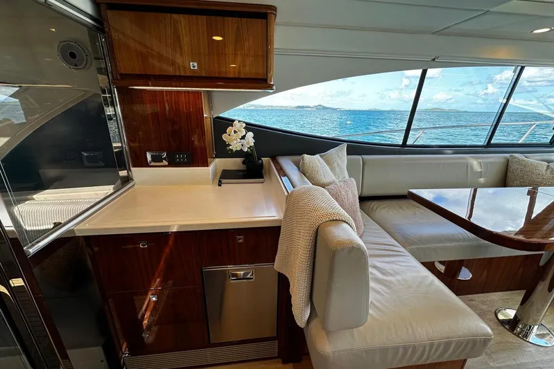  Yacht Photos Pics Luxurious interior of 2023 Riviera 465 SUV yacht with ocean view and elegant seating area.