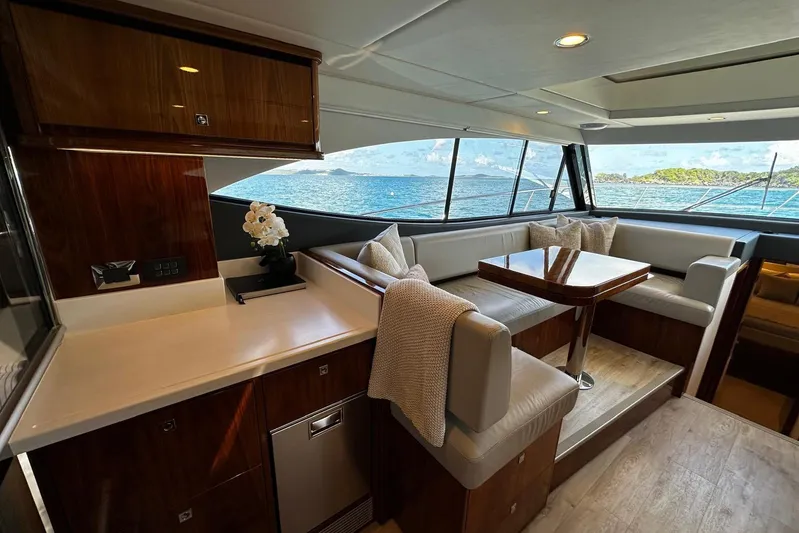  Yacht Photos Pics Luxurious interior of 2023 Riviera 465 SUV yacht with ocean view and elegant seating area.
