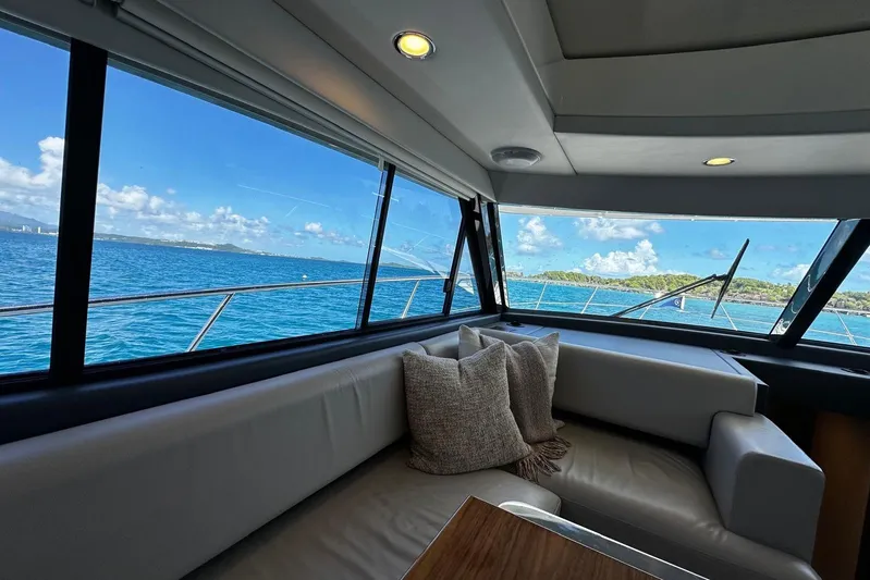  Yacht Photos Pics Interior view of 2023 Riviera 465 SUV yacht with ocean and island scenery.