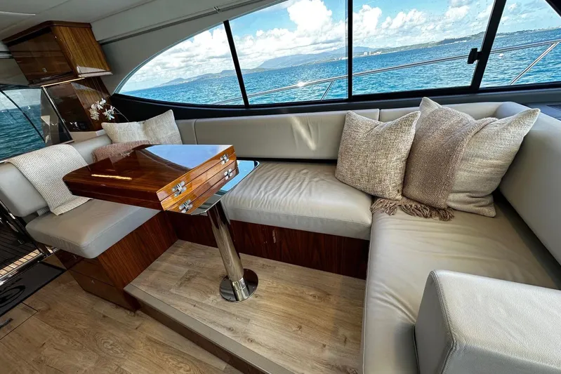  Yacht Photos Pics Luxurious interior of 2023 Riviera 465 SUV yacht with plush seating and ocean view.