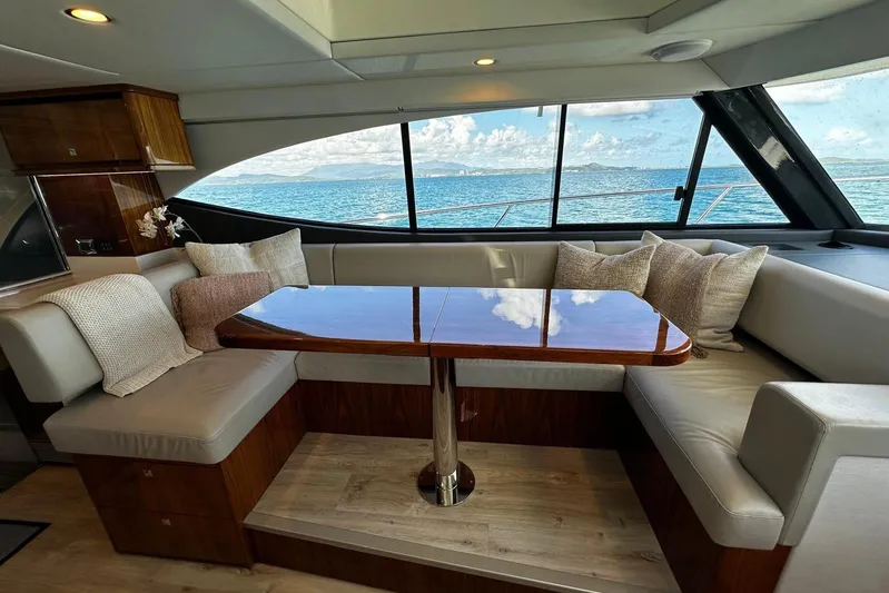  Yacht Photos Pics Luxurious interior of 2023 Riviera 465 SUV yacht with ocean view through large windows.