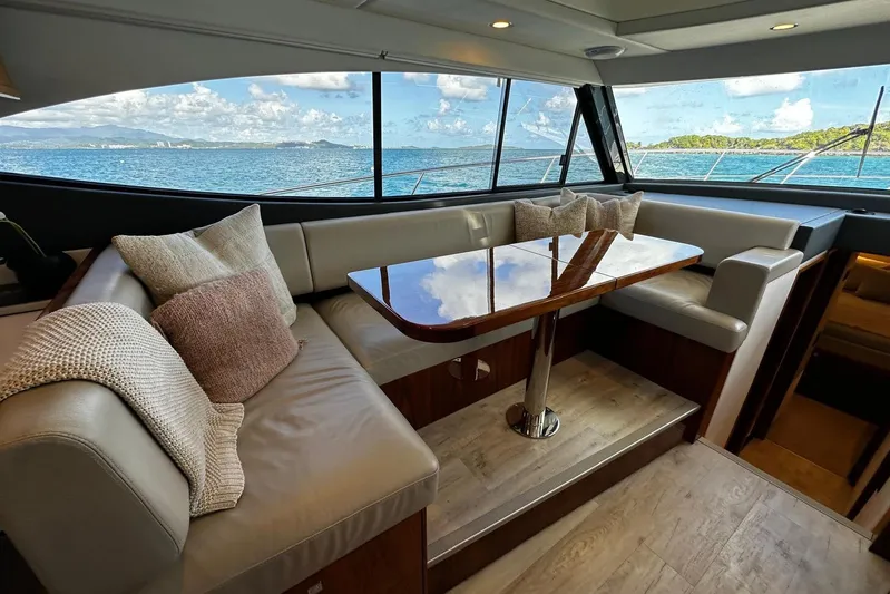  Yacht Photos Pics Luxurious interior of 2023 Riviera 465 SUV yacht with ocean view through large windows.
