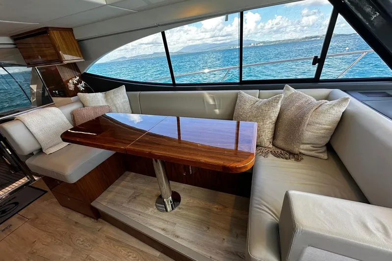  Yacht Photos Pics Luxurious interior of 2023 Riviera 465 SUV yacht with elegant seating and ocean view.