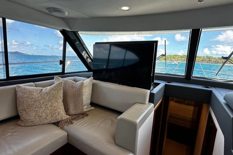  Yacht Photos Pics Luxurious interior of 2023 Riviera 465 SUV yacht with ocean view and plush seating.