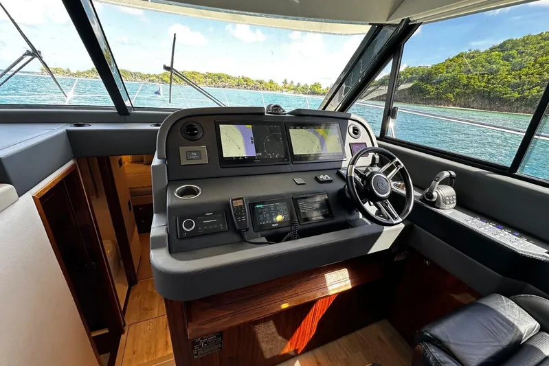  Yacht Photos Pics 2023 Riviera 465 SUV helm with advanced navigation systems and ocean view.