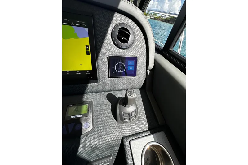  Yacht Photos Pics Control panel of 2023 Riviera 465 SUV with navigation screen and joystick.