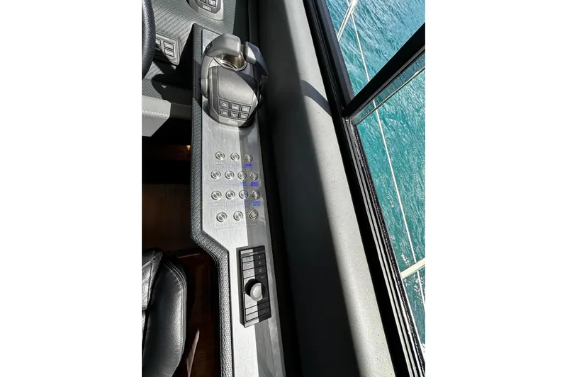  Yacht Photos Pics Control panel of 2023 Riviera 465 SUV yacht with ocean view through window.