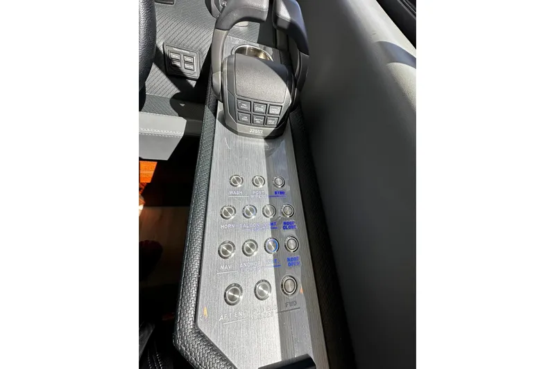  Yacht Photos Pics Control panel of 2023 Riviera 465 SUV with labeled buttons and joystick.