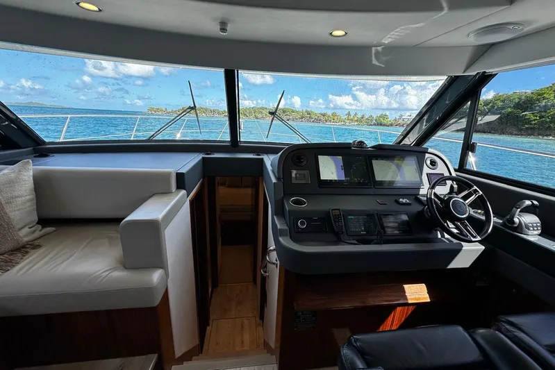  Yacht Photos Pics Interior view of 2023 Riviera 465 SUV yacht cockpit with ocean backdrop.