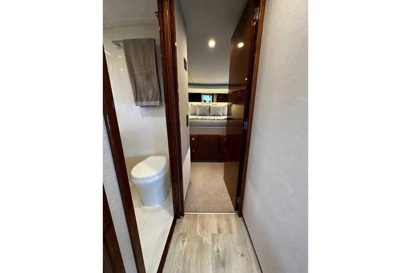  Yacht Photos Pics Interior of 2023 Riviera 465 SUV yacht, featuring a bathroom and cozy bedroom.