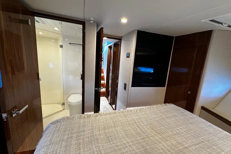  Yacht Photos Pics Luxurious interior of 2023 Riviera 465 SUV yacht with modern bathroom and cozy bedroom.