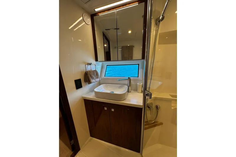  Yacht Photos Pics Luxurious bathroom in 2023 Riviera 465 SUV yacht with modern fixtures and ocean view.