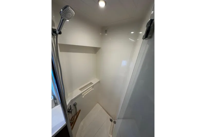  Yacht Photos Pics Shower area in 2023 Riviera 465 SUV, featuring modern fixtures and sleek design.